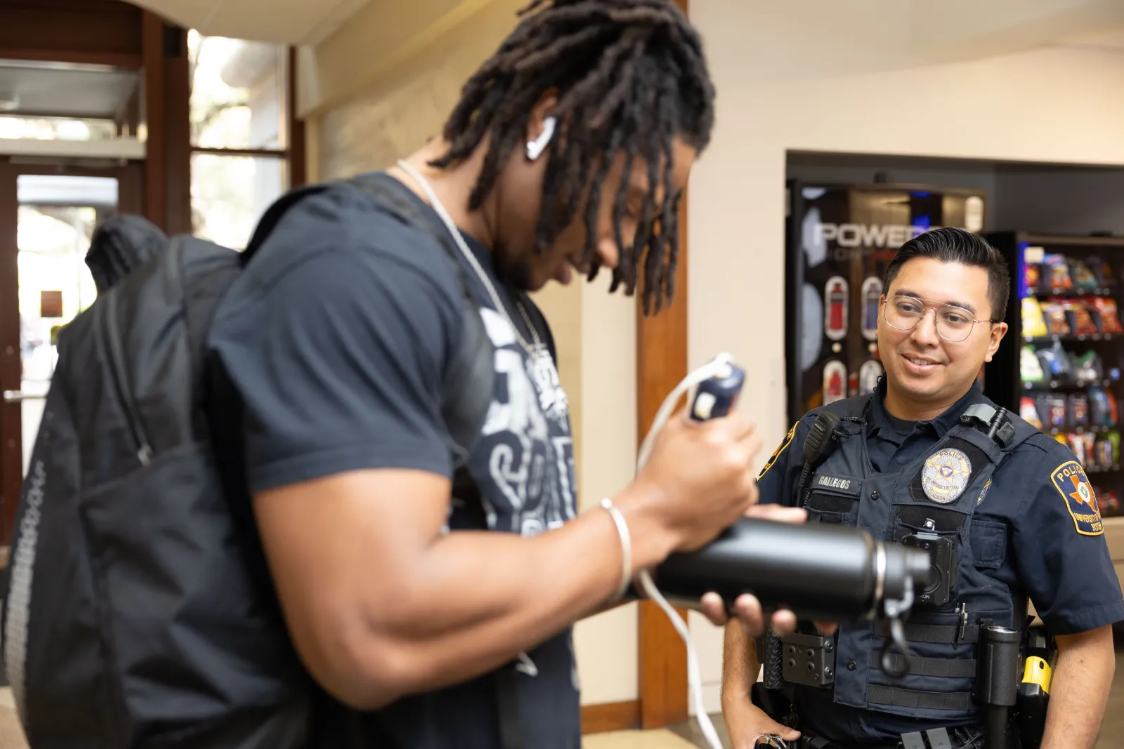 Student engraves his bottle with Ofc. Gallegos